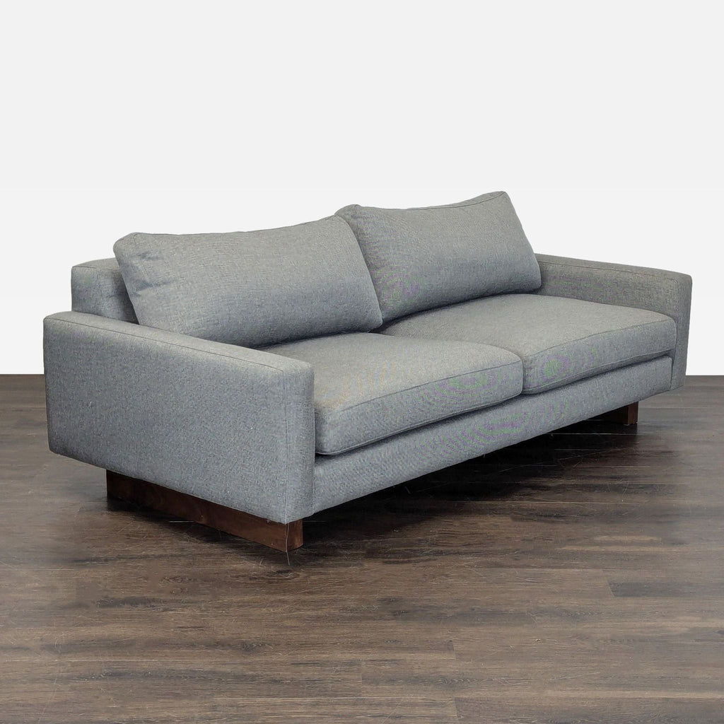 Contemporary Room & Board loveseat in neutral gray fabric, seats two, with clean design and comfortable cushioning.