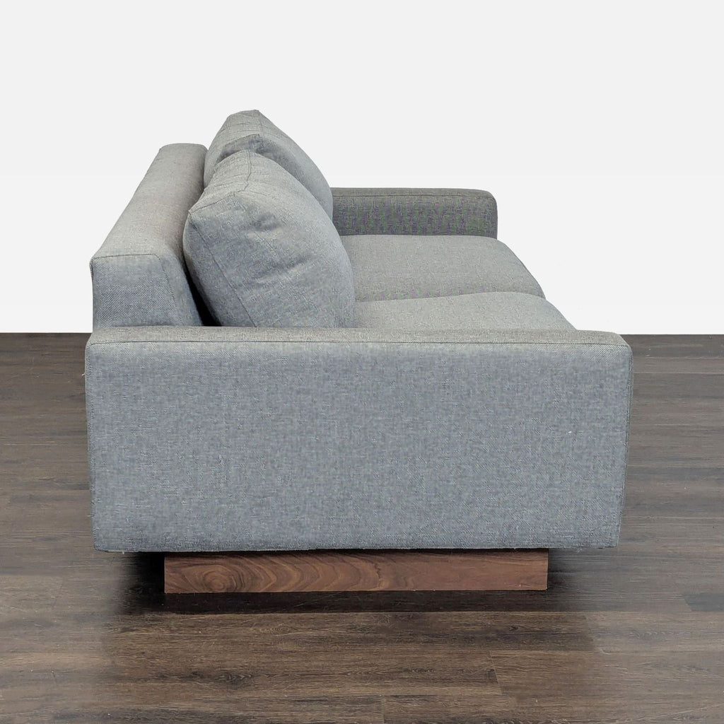 Modern gray loveseat by Room & Board, featuring sleek lines, soft seating, and sturdy wooden legs; gently used.