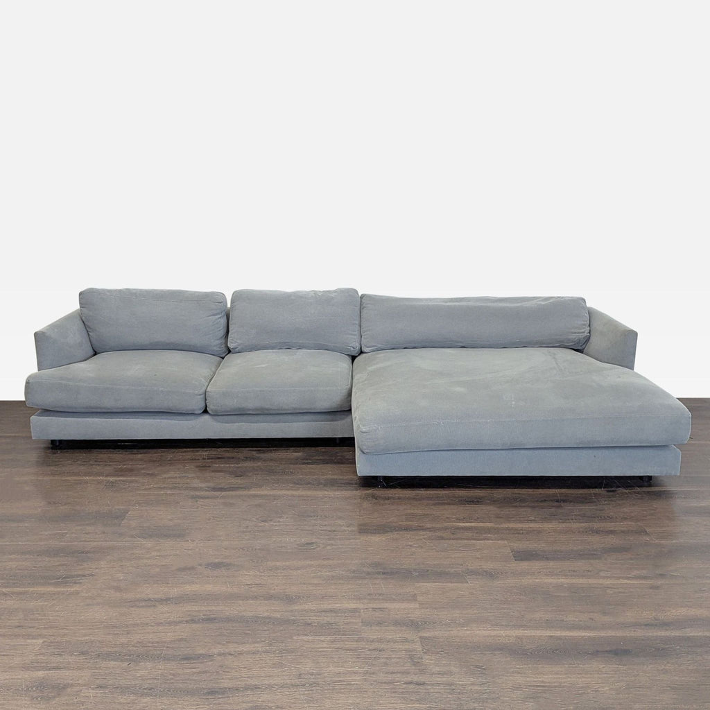 West Elm sectional with soft gray fabric and chaise, modern design, and supportive plush cushions.