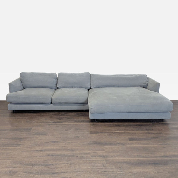 West Elm sectional with soft gray fabric and chaise, modern design, and supportive plush cushions.