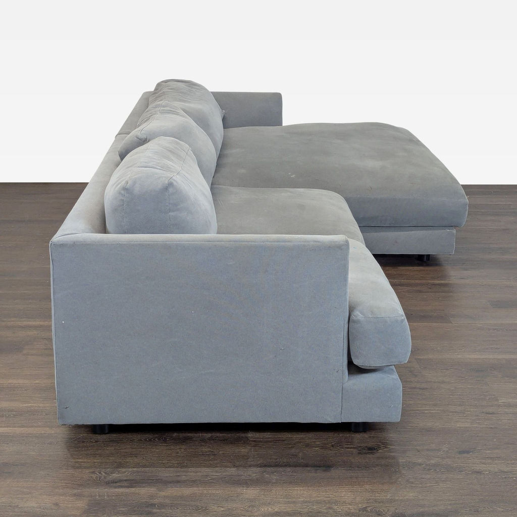 Gray West Elm sectional sofa featuring a spacious chaise lounge, ideal for modern living rooms.