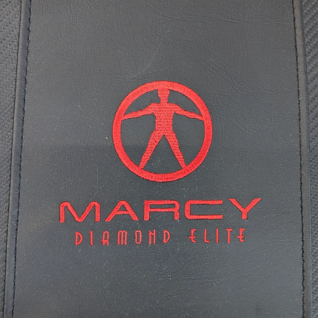 Compact Marcy exercise machine featuring sturdy frame, foam rollers, and black-and-red details.
