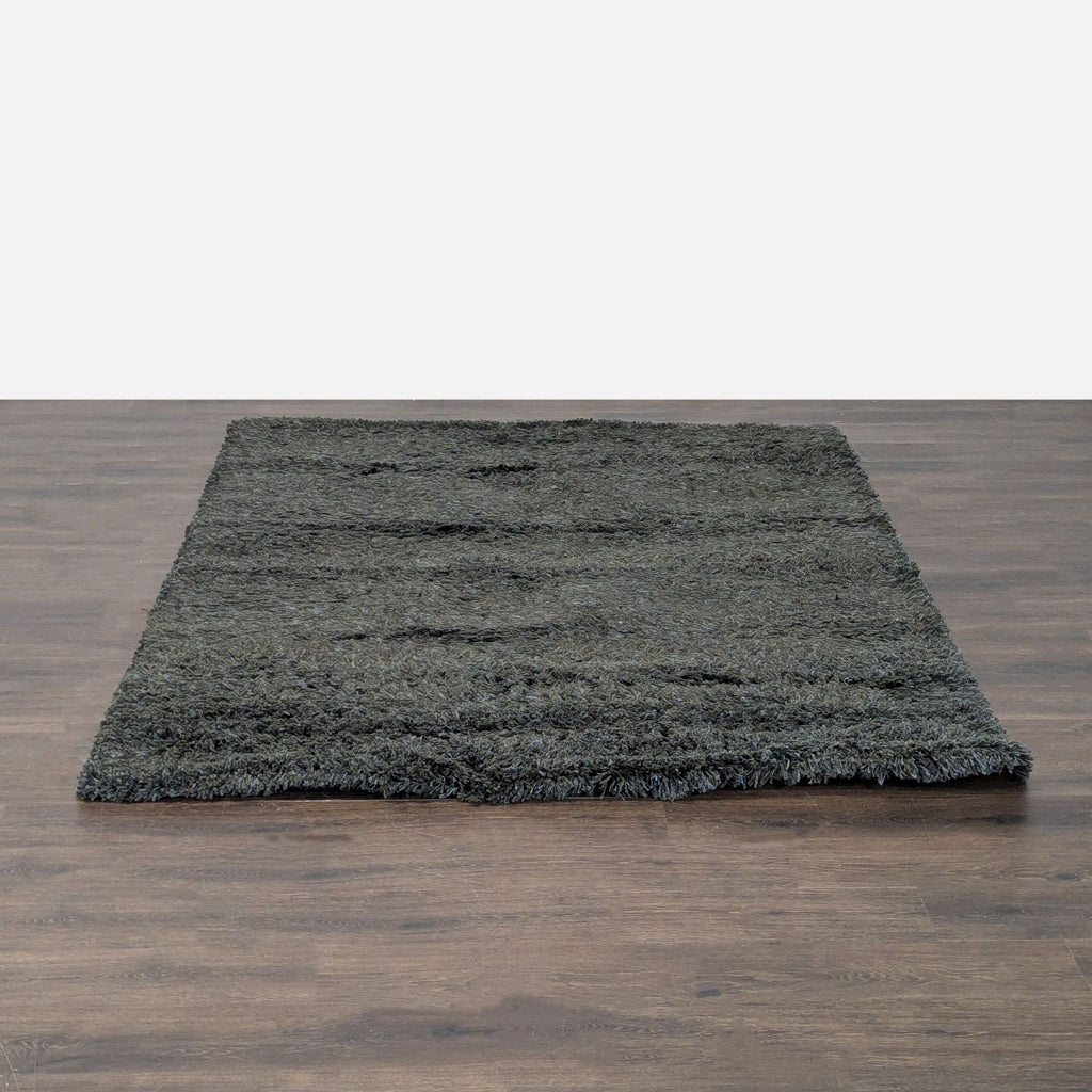 Soft dark gray shag rug with thick, plush texture, perfect for adding comfort to living rooms or bedrooms.