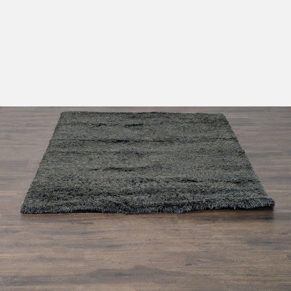 Soft dark gray shag rug with thick, plush texture, perfect for adding comfort to living rooms or bedrooms.