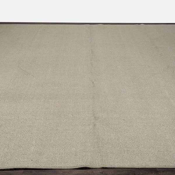 Neutral large rug with subtle woven texture, perfect for adding comfort and style to any room.