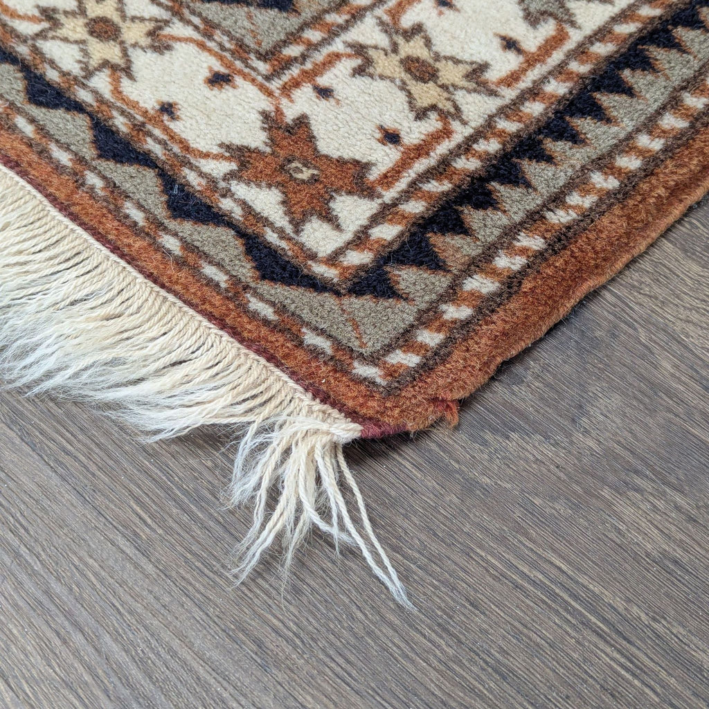 Modern rug featuring a bold geometric pattern and fringed borders, ideal for living spaces or bedrooms.