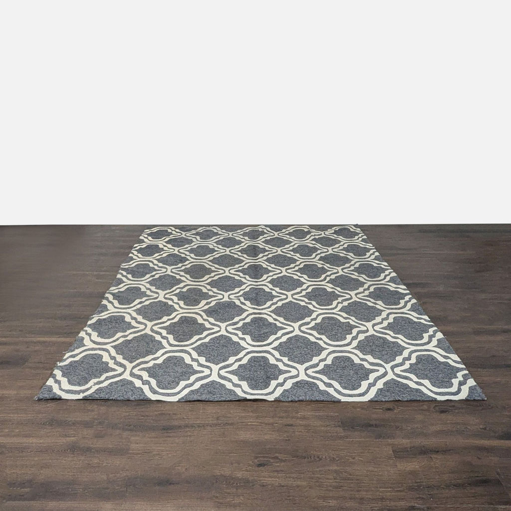 Tommy Bahama rug with a gray base and cream geometric design, ideal for modern living spaces.