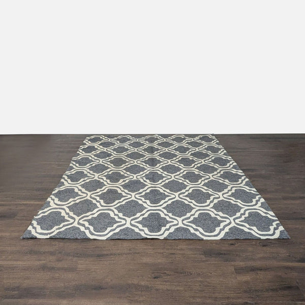 Tommy Bahama rug with a gray base and cream geometric design, ideal for modern living spaces.