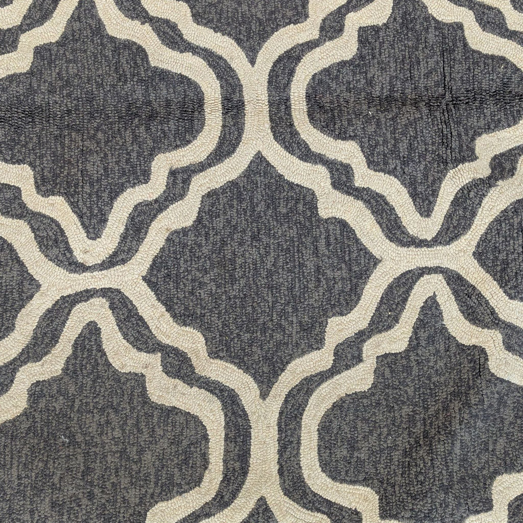 Neutral-colored area rug by Tommy Bahama featuring a stylish cream pattern on a gray background.