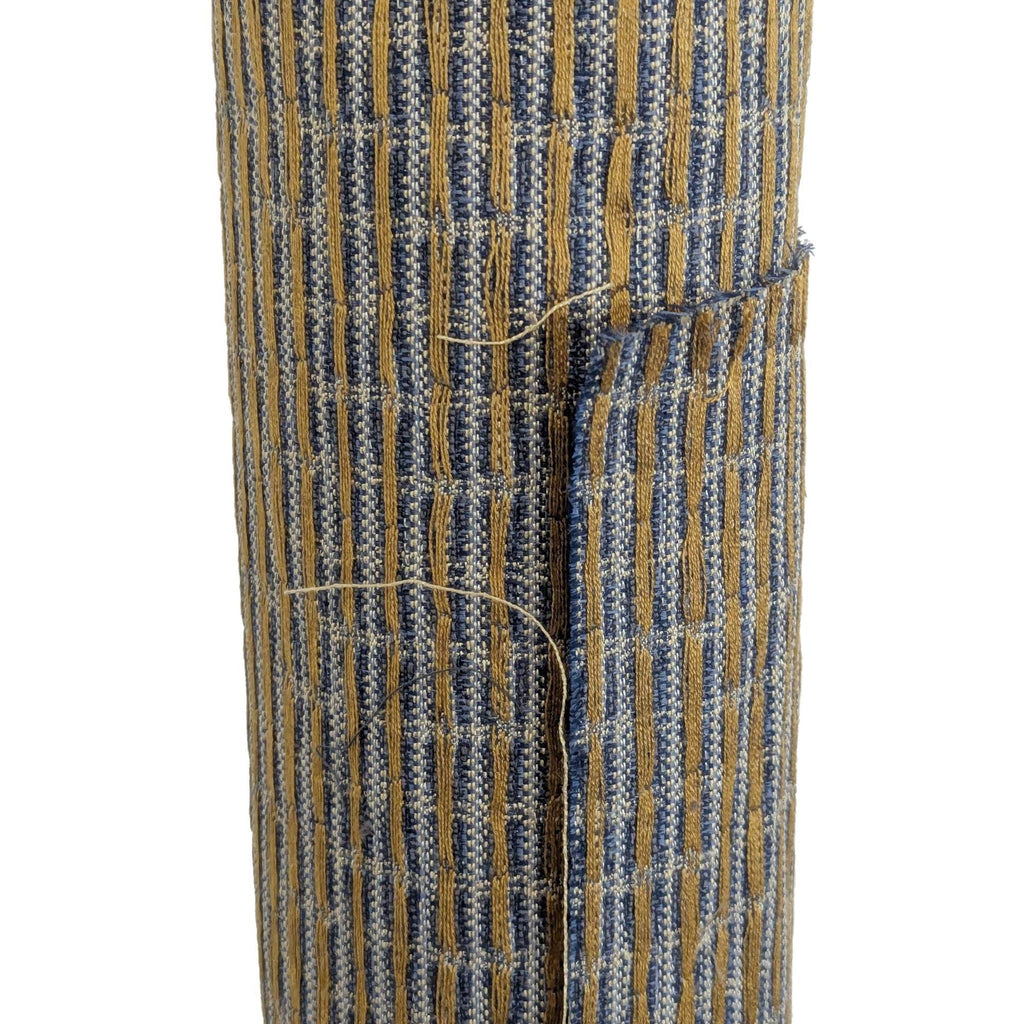 Close-up of blue and tan woven fabric with visible texture, showing detailed stitching and threads.