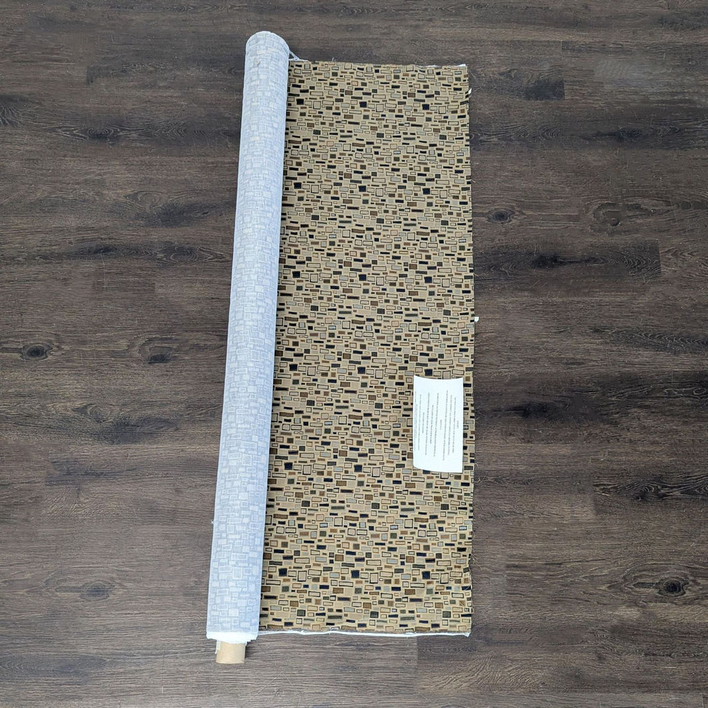 Fabric roll with a modern geometric rectangle pattern in brown, blue, and green on beige, by Gildar Designs.