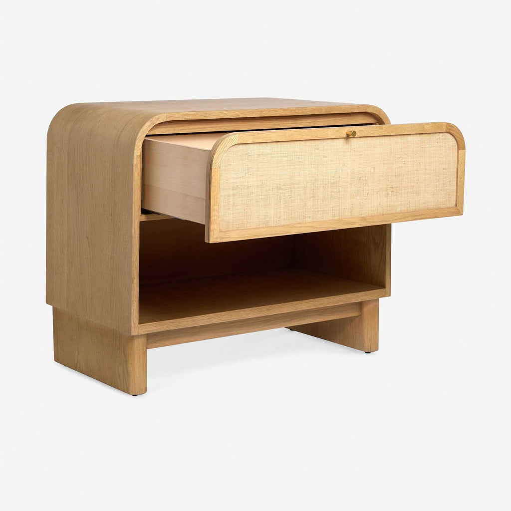 Rounded oak nightstand by Lulu and Georgia, featuring grass cloth accents, one drawer, and open shelf.  