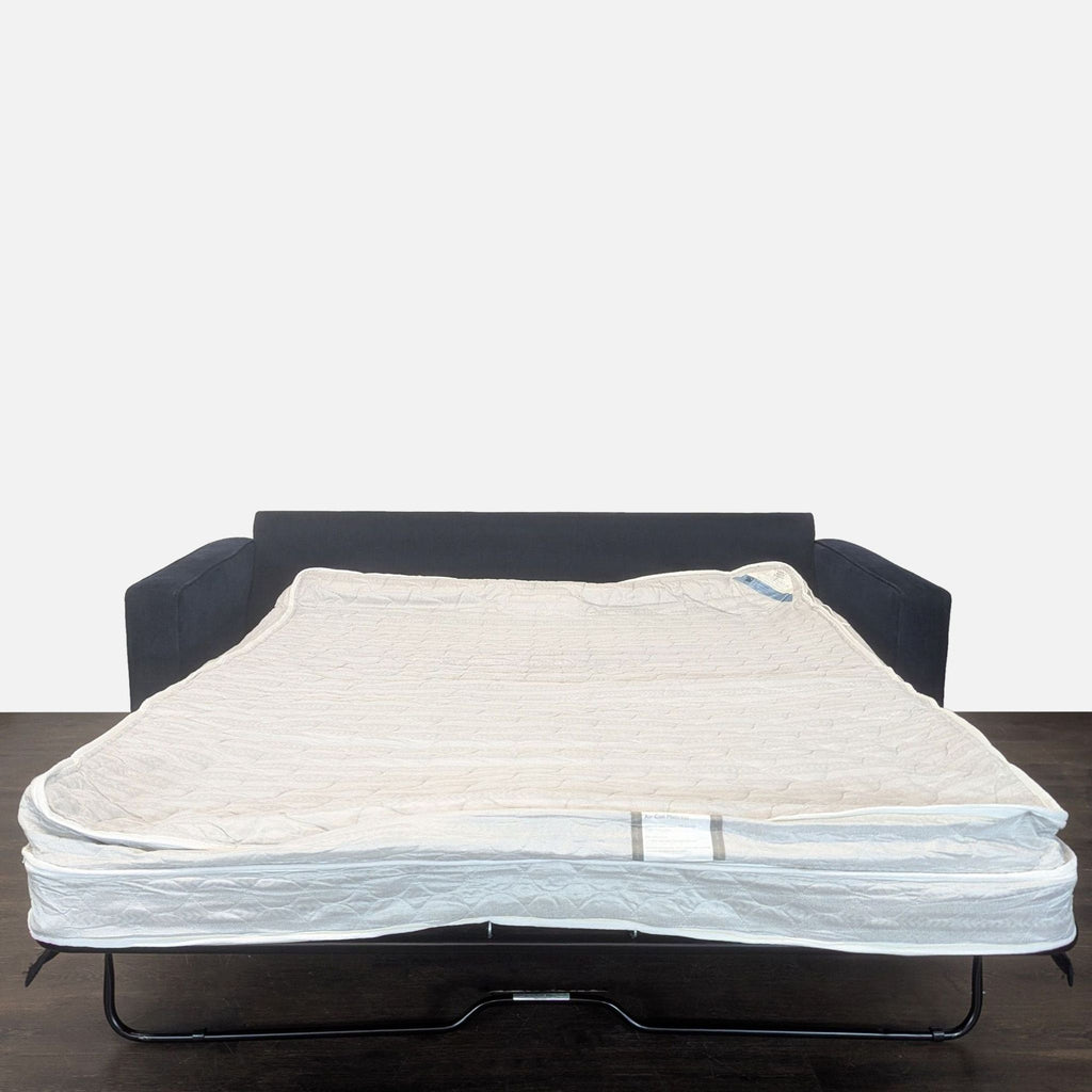 Modern sleeper sofa in navy, featuring a spacious pull-out bed and air coil mattress for added comfort.