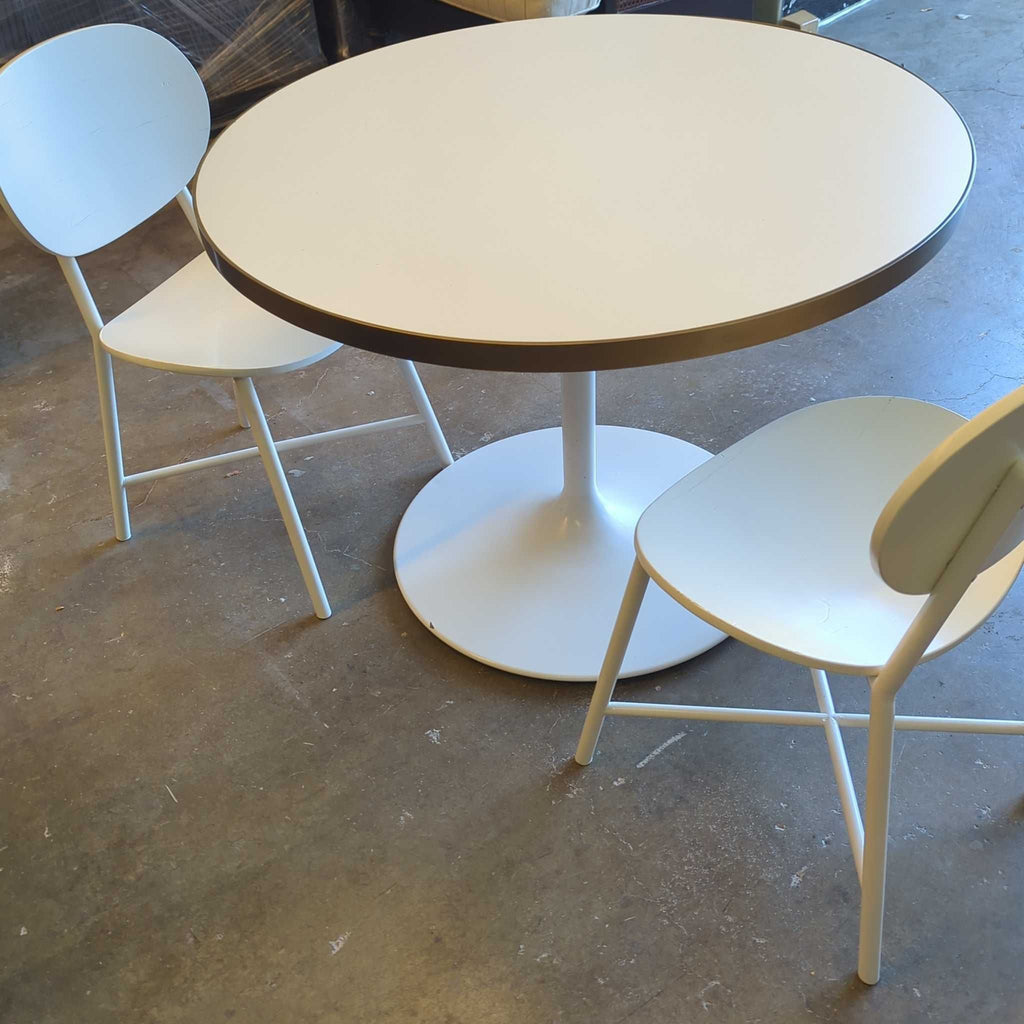 2. Contemporary dining set featuring a sleek table and cushioned chairs, arranged for four people.  