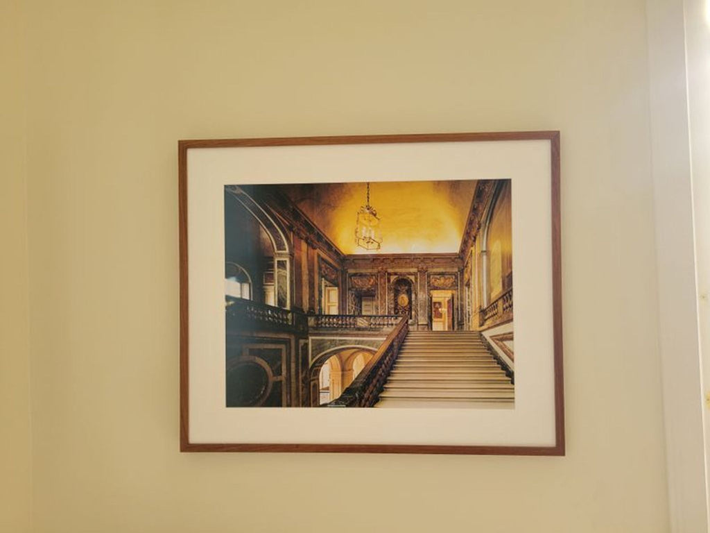 Art print depicting a grand staircase, framed and matted, ideal for sophisticated home or office wall display.