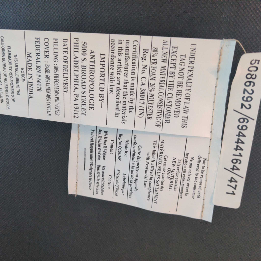 Close-up of the manufacturer tag on a lounge chair, listing materials, brand, and certification details.