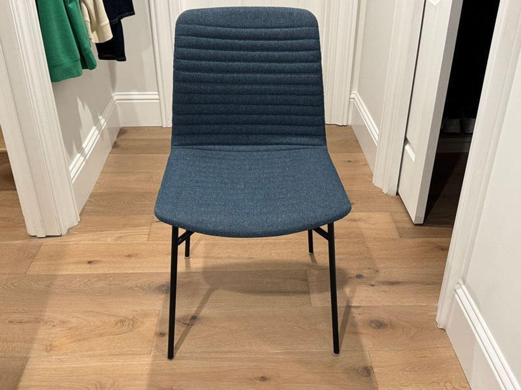 1. Modern Room & Board dining chair with clean lines and a sleek, minimalist silhouette.