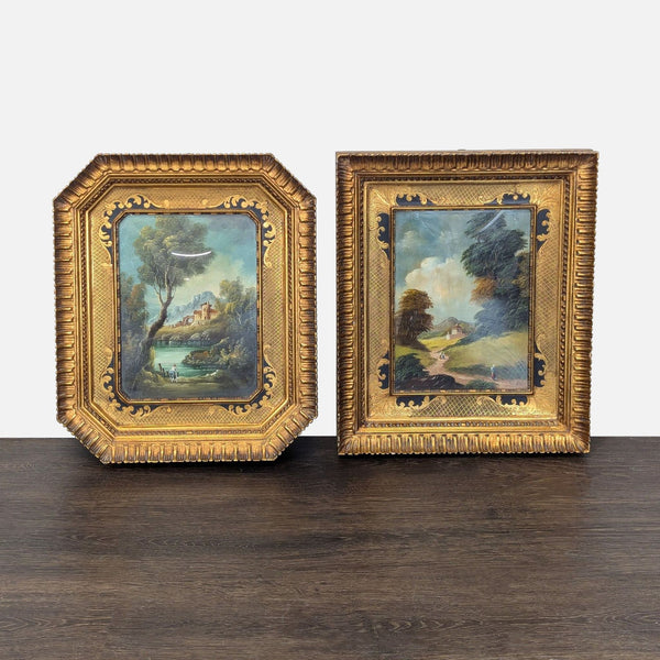 Pair of antique landscape paintings in ornate gold frames, showing tranquil countryside scenes with trees and water.  