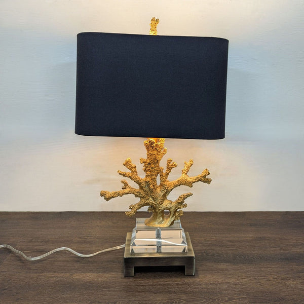 Gold faux coral table lamp with a textured base and black rectangular shade, ideal for modern spaces.  