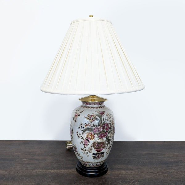 Oriental Accent table lamp with a floral ceramic base, cream lampshade, and gold-tone top accent.