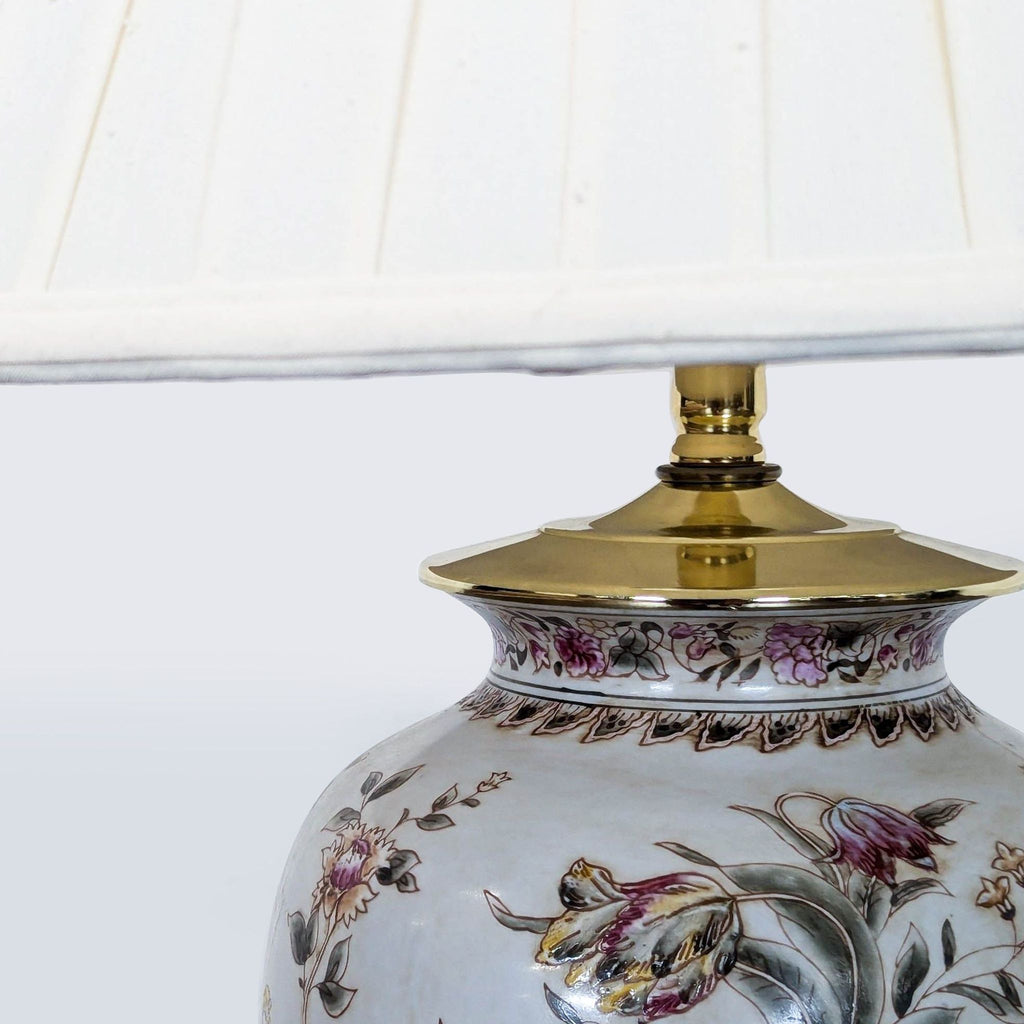 Ceramic table lamp featuring soft floral patterns, a cream shade, and elegant gold detailing at the top.
