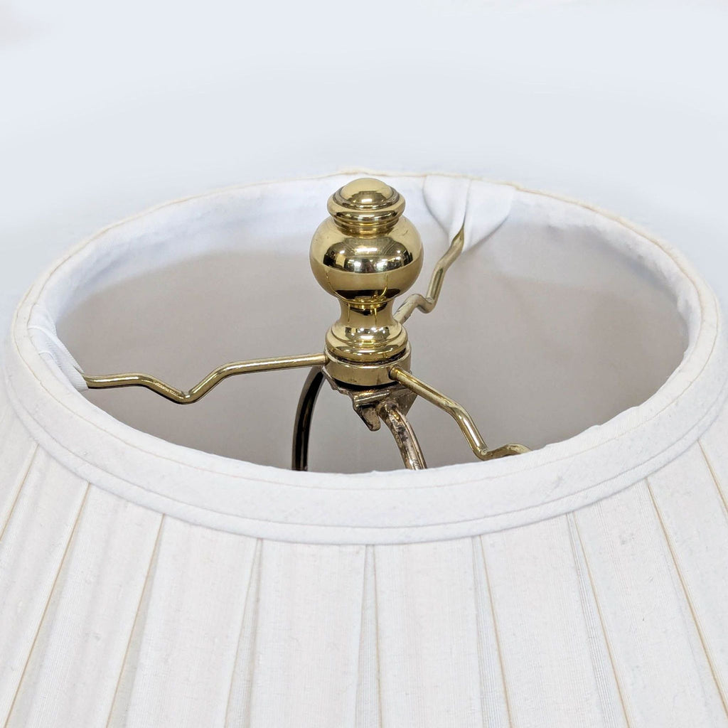 Lighting piece with floral-patterned ceramic base, classic cream lampshade, and shiny gold-tone accent.