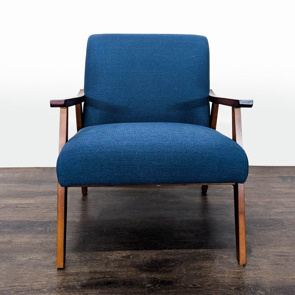 Blue lounge chair with wooden frame and armrests, offering a modern, minimalist design for living spaces.