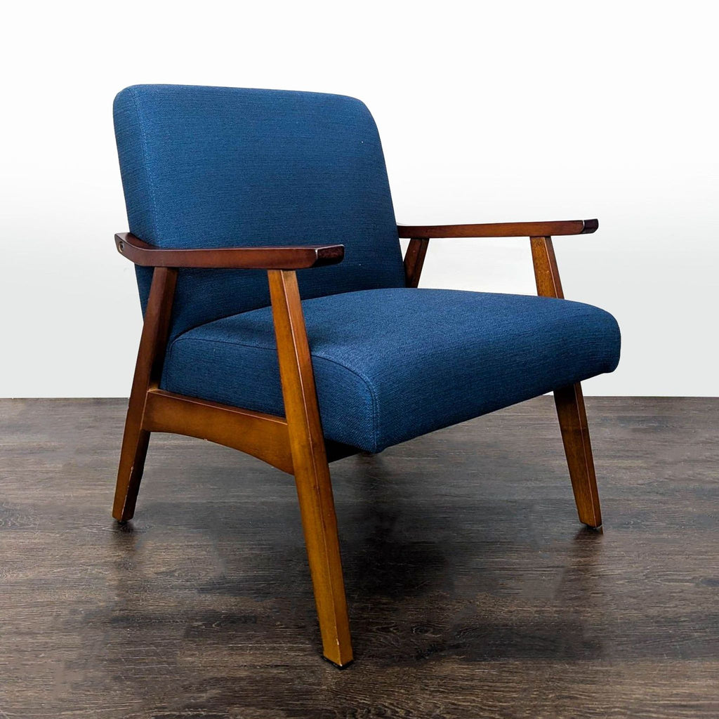 Stylish lounge chair featuring blue fabric upholstery, wooden arms, and a comfortable seat for relaxation.