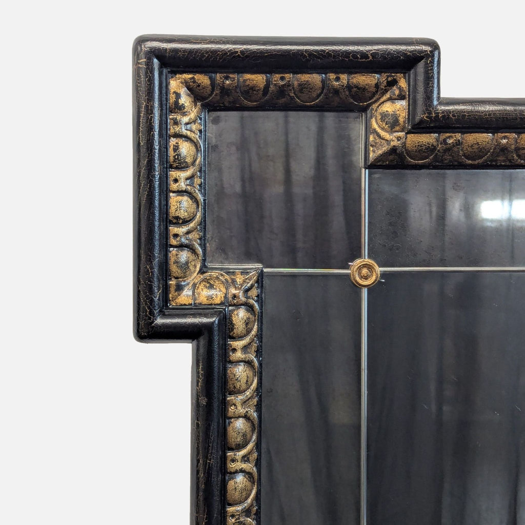 Ethan Allen Turret Mirror with a multi-paneled, antiqued wood frame in black and gold, accented with nickel rosettes.