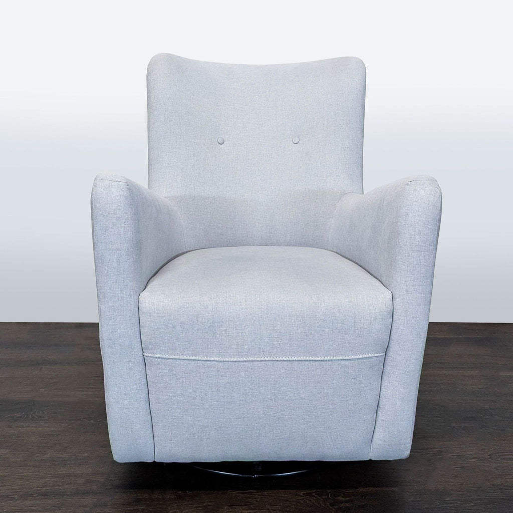 Soft grey Pottery Barn Kids lounge chair with supportive design and swivel base, ideal for nurseries or playrooms.