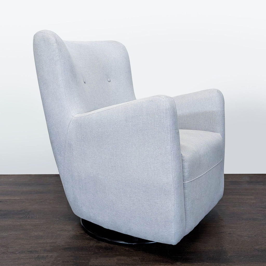 Grey lounge chair from Pottery Barn Kids with cozy cushions and a rotating base, perfect for any kids’ space.