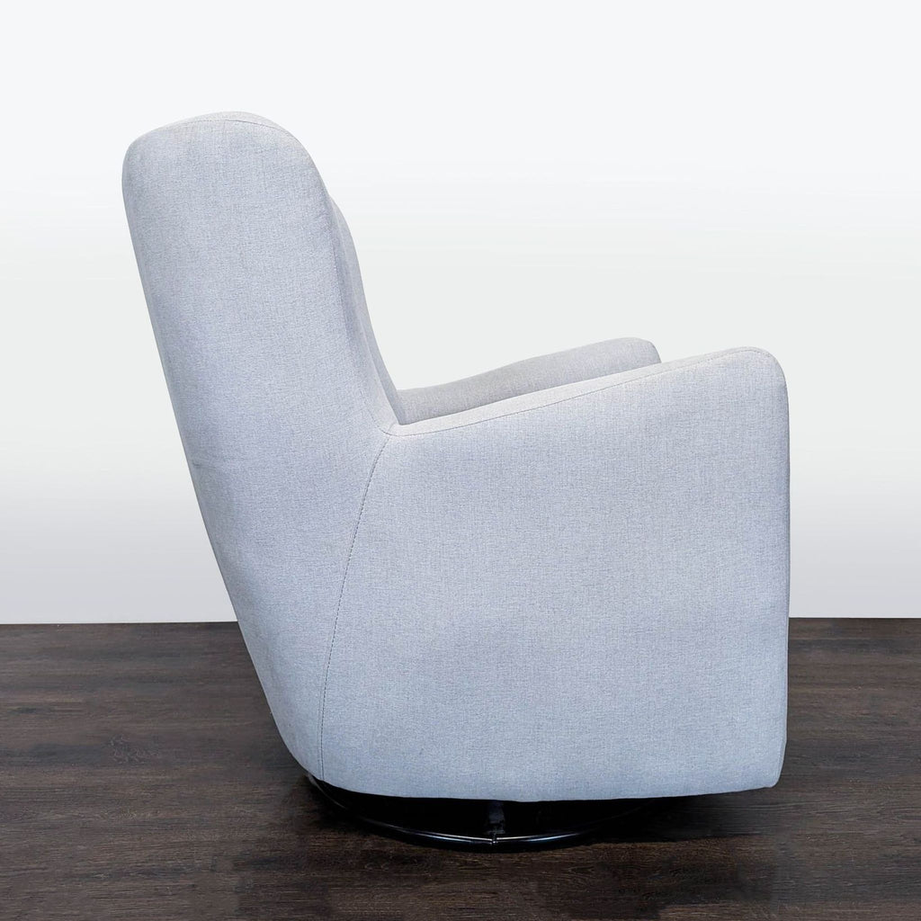 Pottery Barn Kids lounge chair in light grey fabric featuring a smooth swivel base and plush comfort for children.