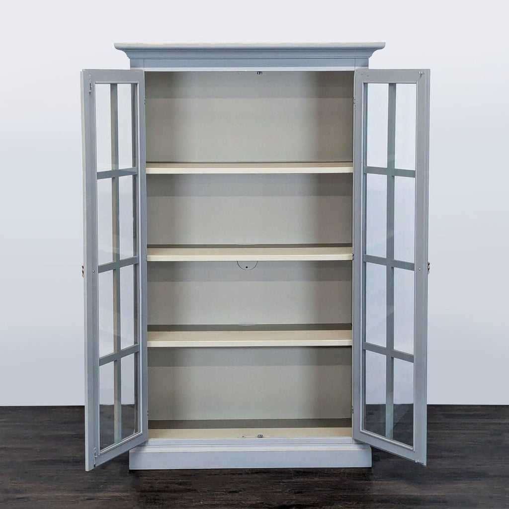 Gray bookshelf from Crate & Barrel featuring glass doors and multiple shelves for stylish storage or display.