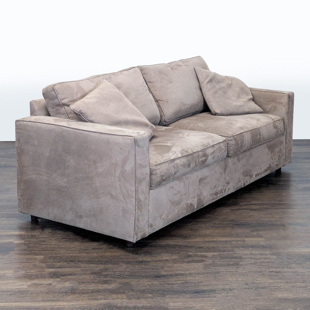Contemporary neutral three-person Room & Board sofa with straight arms, plush comfort, and matching accent pillows.