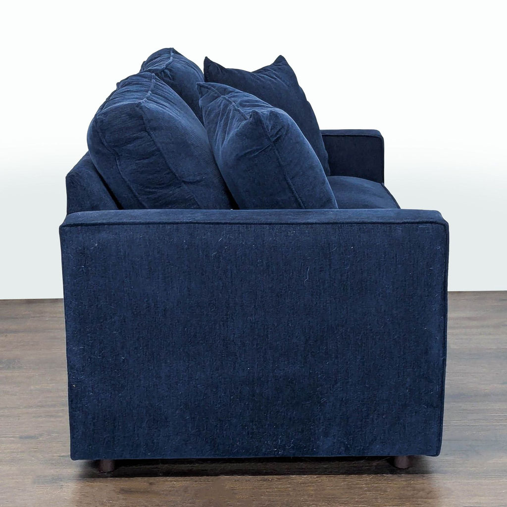 Gently used Room and Board loveseat in rich blue fabric, ideal for small spaces, includes two pillows.