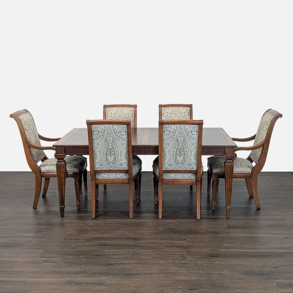 Ethan Allen dining set with wooden table, carved legs, and six upholstered chairs in a classic style.  