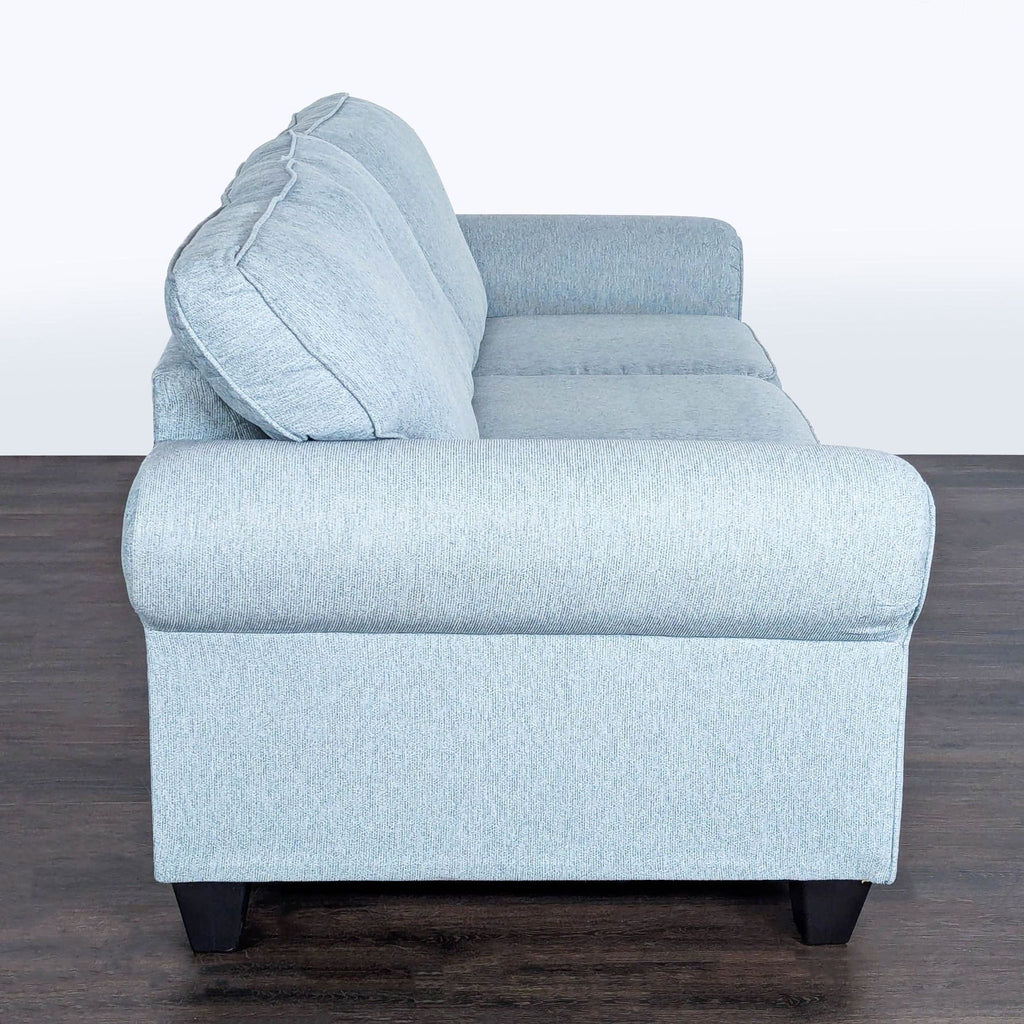 2. Minhas Furniture House 3-seater couch featuring plush cushions and contemporary wooden legs.