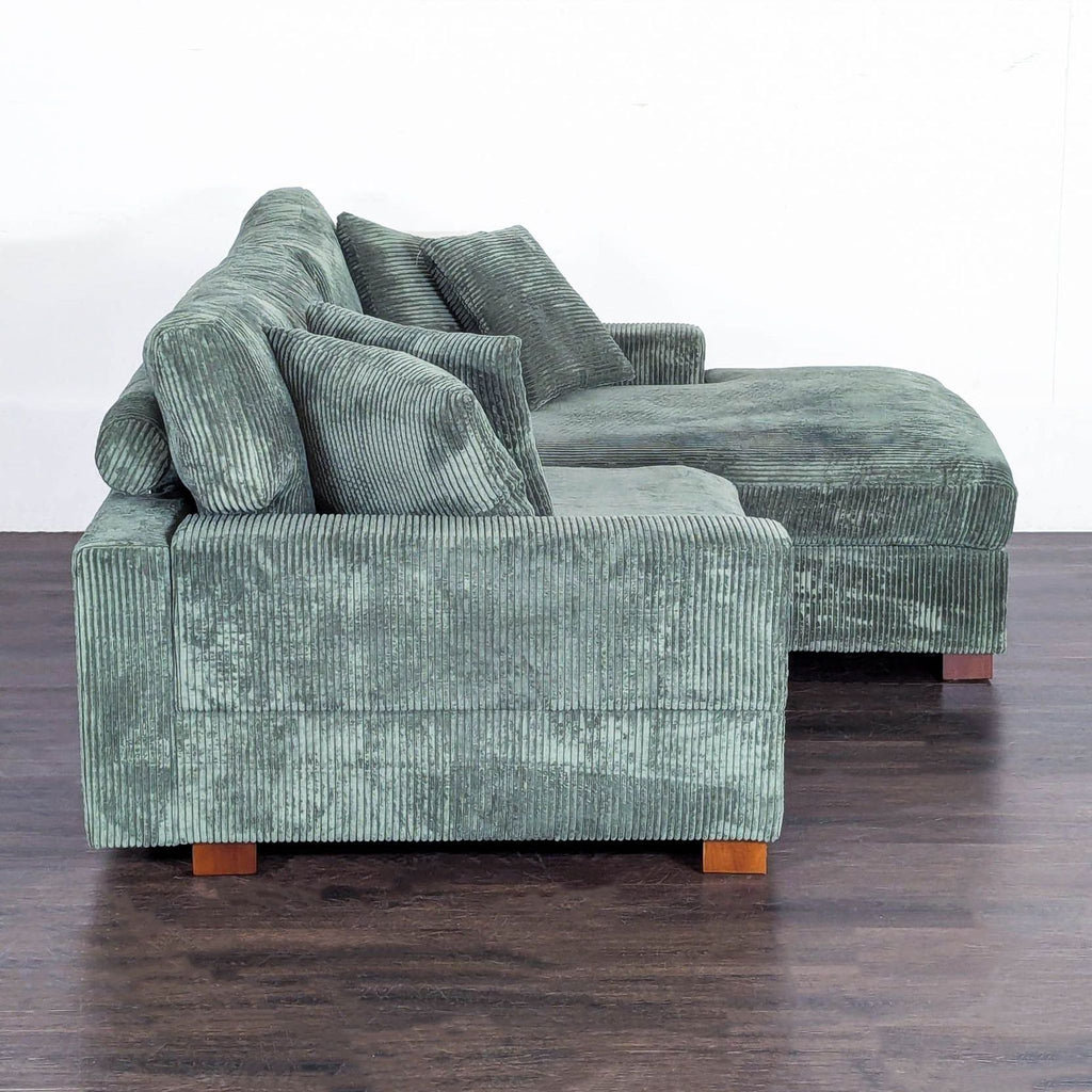 Uixe brand green sectional sofa in polyester faux rabbit fur, L-shaped with square arms and four included pillows.