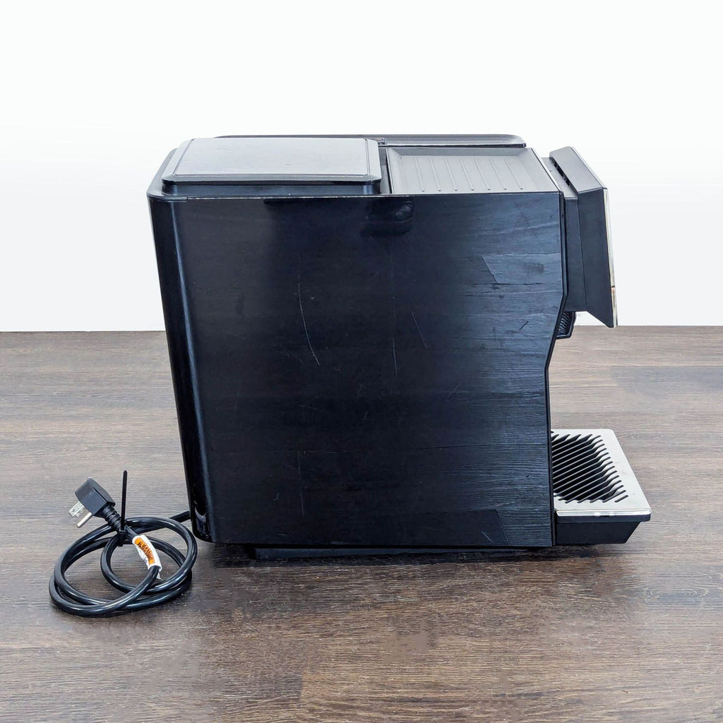 Compact Bosch coffee maker with a modern black finish, user-friendly touch display, and WiFi connectivity for smart use.