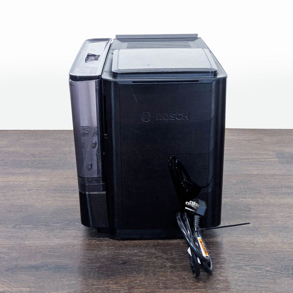 Stylish Bosch coffee maker in black, featuring a clear touchscreen, large water tank, and convenient compact size.