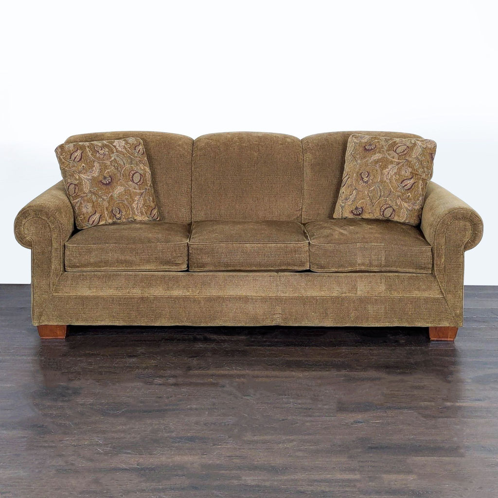 La-Z-Boy brown sleeper sofa with rolled arms, patterned pillows, and pull-out bed for added sleeping space.  