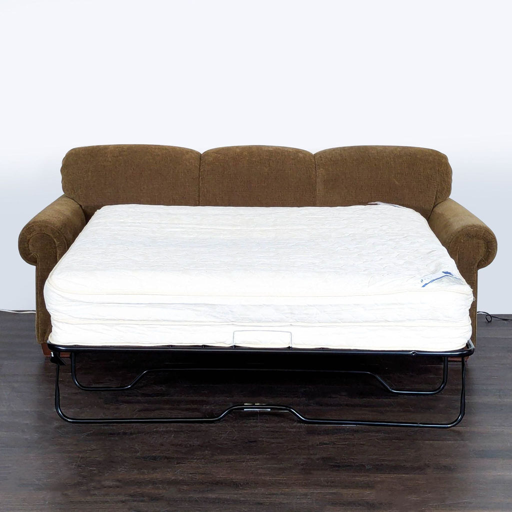 Sleeper sofa by La-Z-Boy, featuring soft brown upholstery, decorative pillows, and a convenient pull-out bed design.  