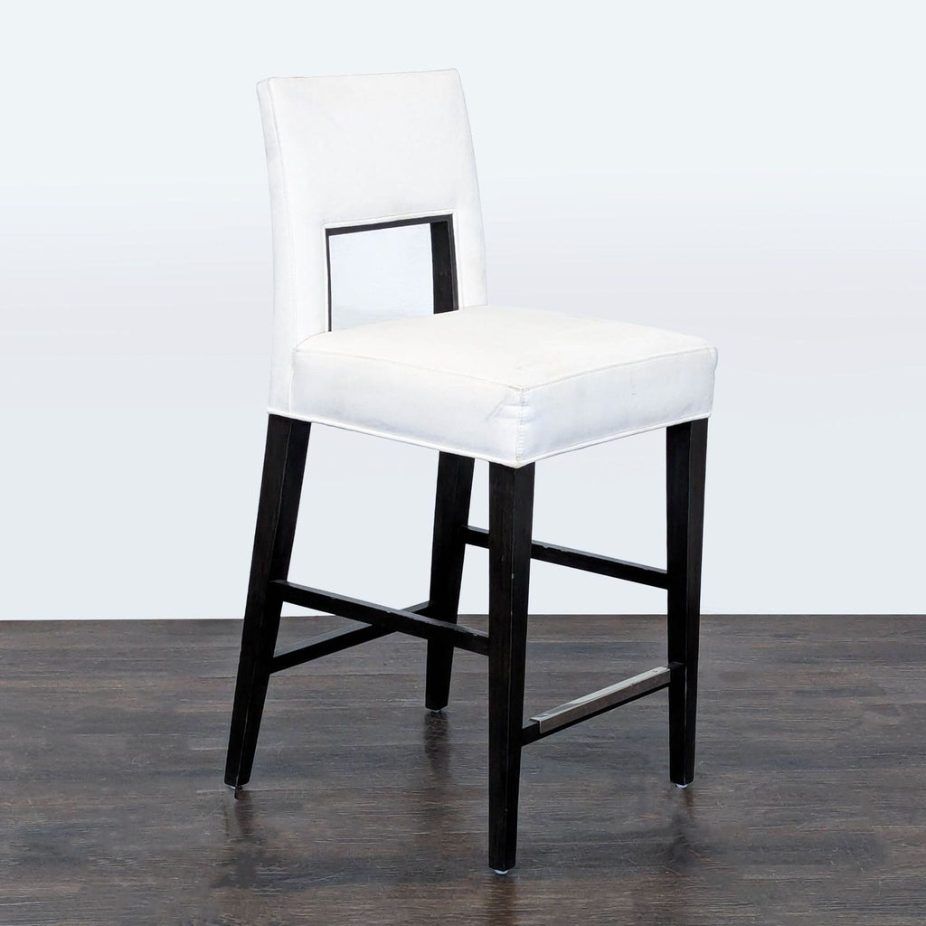 1. Modern upholstered ottoman by Rene Cazares, featuring clean lines and soft fabric in neutral tones.