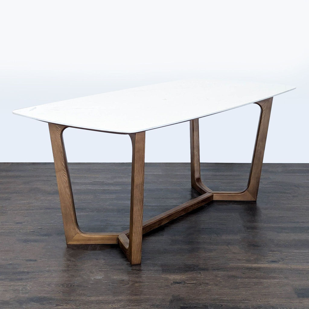Modern dining table with ash wood legs and a smooth marble top, Rove Concepts brand.  