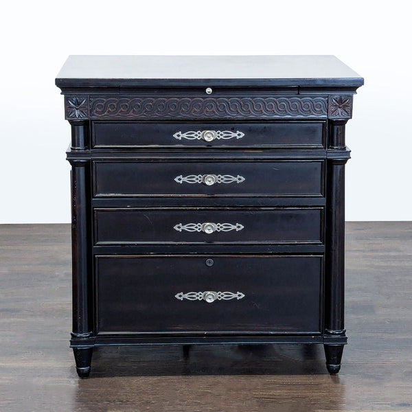 Aspen Home black end table with elegant carvings, four drawers, and a slide-out tray with outlets.