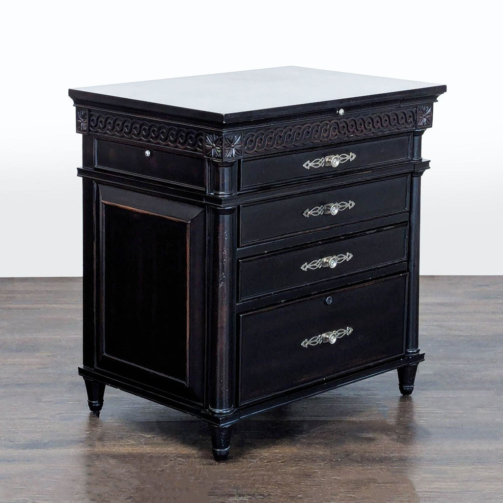 Aspen Home end table in black, showcasing carved details, four drawers, and handy outlet-equipped tray.