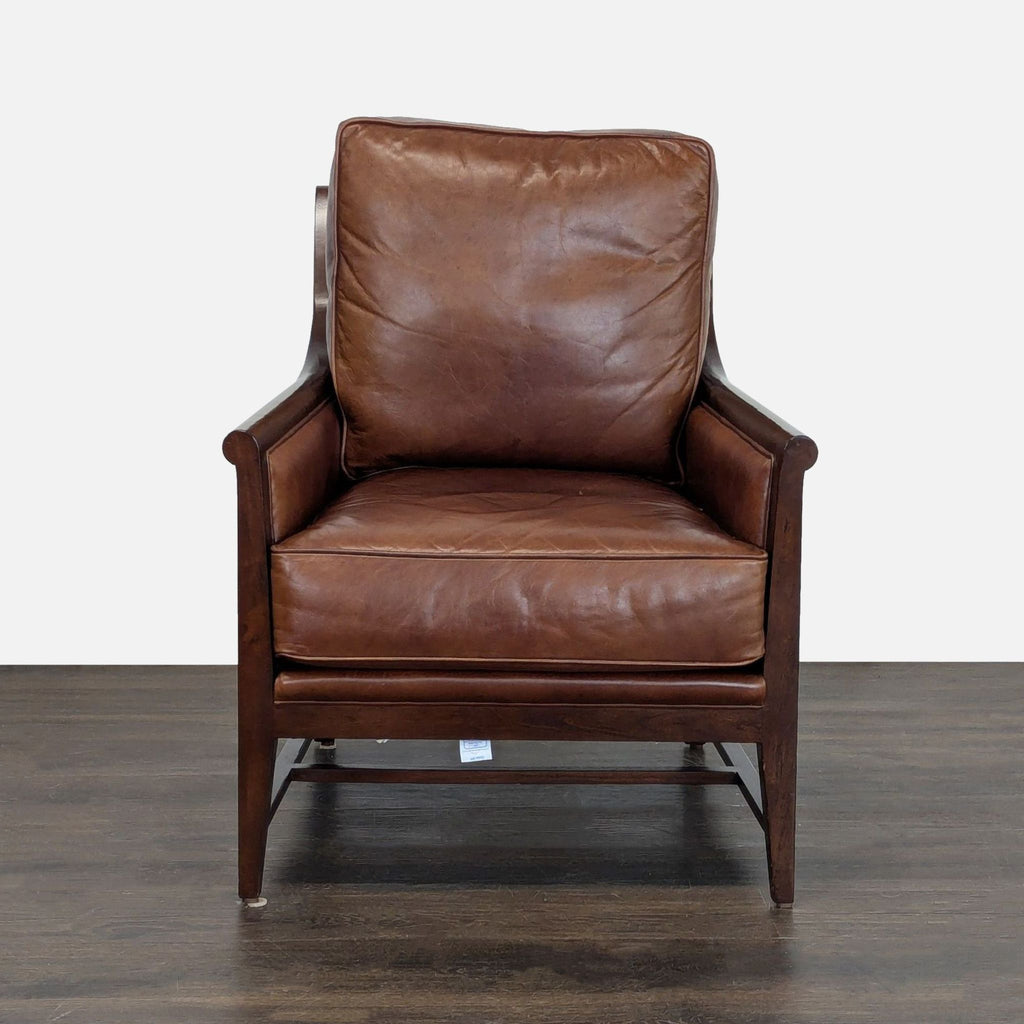 Brown leather lounge chair with plush cushions and a wooden frame, ideal for stylish living room comfort.