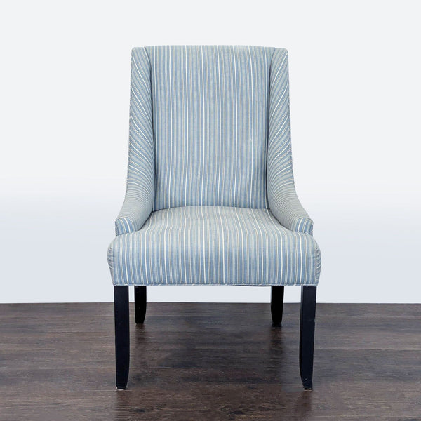 Blue and white striped lounge chair with padded seat, tall back, and dark wooden legs for modern comfort.  