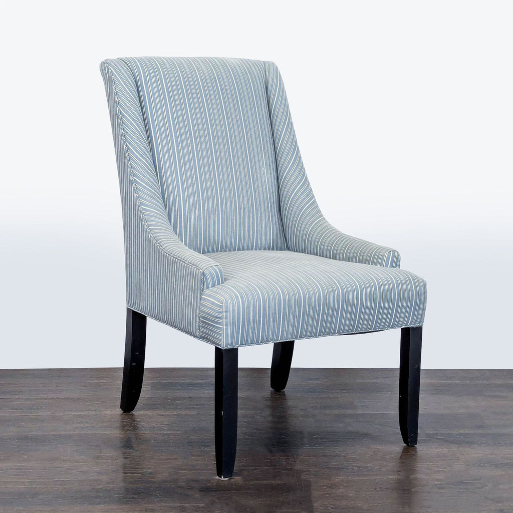 Modern lounge chair featuring curved armrests, supportive back, and stylish striped upholstery on dark wood legs.  