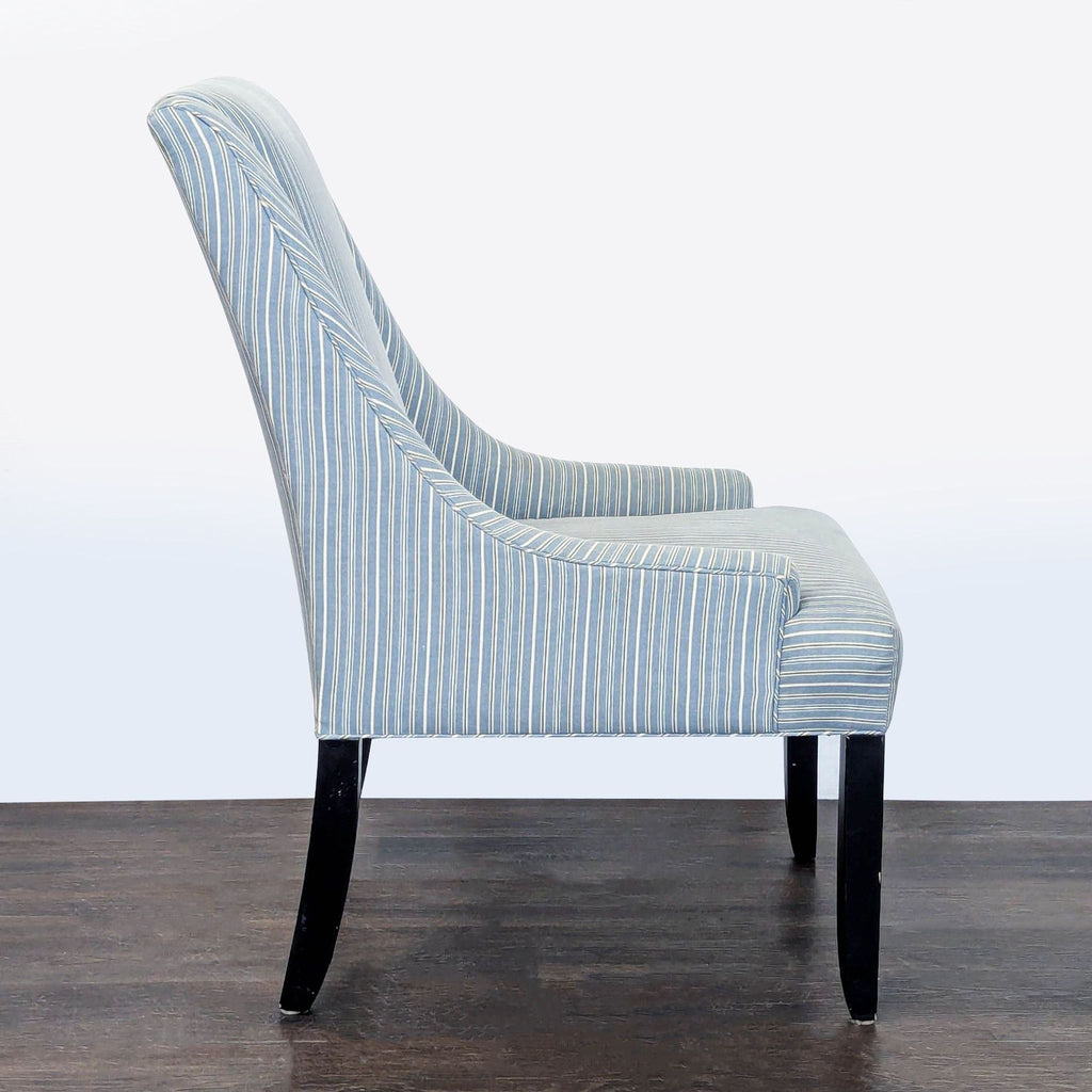 Comfortable striped lounge chair with plush padding, sleek armrests, and sturdy dark wooden legs for living spaces.